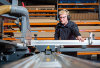 A photo of a Shelving 4 Shops joiner cutting panels on a table saw